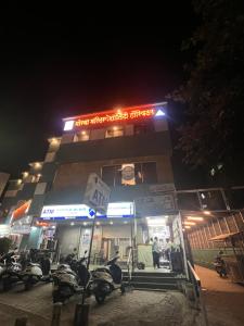 a building with motorcycles parked in front of it at night at Backpackers hostel in Pune