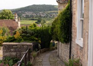 an alley in a house with a hill in the background at Charming 2BD Cottage wIth beautiful views nr Bath in Batheaston