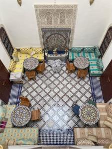 an overhead view of a living room with tables and chairs at Riad Fes Colors & Spa in Fez