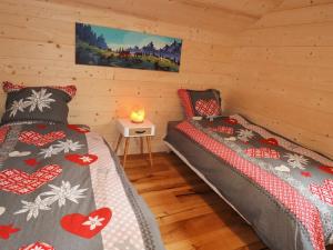 a bedroom with two beds in a cabin at Chalet Samoëns, 5 pièces, 8 personnes - FR-1-624-118 in Samoëns