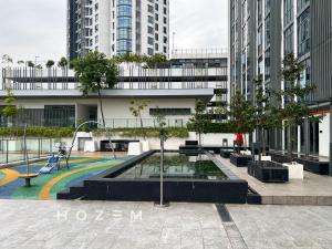 a playground in the middle of a city with tall buildings at Comfort Pool View Studio 5PX Near Mid Valley in Kuala Lumpur