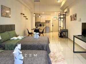 a bedroom with two beds and a living room at Comfort Pool View Studio 5PX Near Mid Valley in Kuala Lumpur
