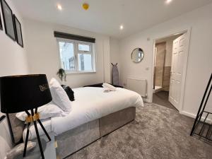 a bedroom with a large white bed and a window at Monthly Stays Liverpool in Liverpool