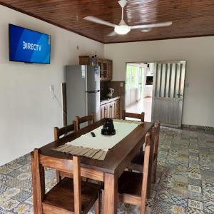 a kitchen with a wooden table with chairs and a refrigerator at CASABLANCA APARTAMENTOS in San Roque