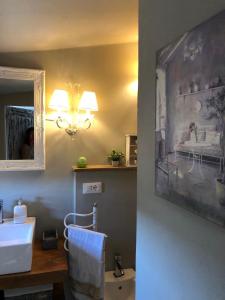 a bathroom with a sink and a mirror and a toilet at Dolce Cuore luxe apartment chianti florence Małe romantyczne mieszkanie in San Donato in Poggio