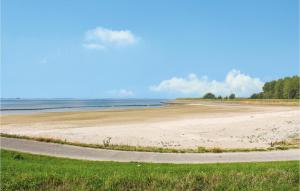 a view of a beach with a road at Stunning Home In Scherpenisse in Scherpenisse