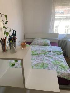 a bedroom with a bed and a desk and a table at Kleine Wohnung im Zentrum Graz in Graz