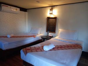 Postel nebo postele na pokoji v ubytování Baanfai Guesthouse Chiangkhong