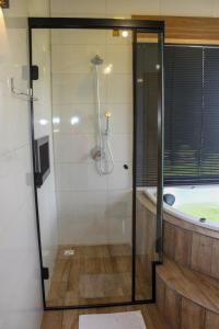 a bathroom with a shower and a bath tub at Chale com Wi-Fi e muito lazer em Bom Retiro SC in Bom Retiro +28 photos