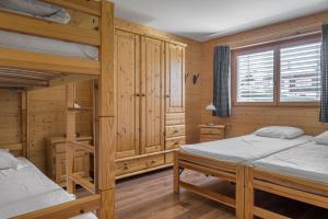 a bedroom with two bunk beds and a window at Laackerhof in Bettmeralp