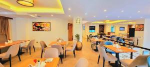 a restaurant with tables and chairs in a room at TH BonRoyal Hotel in Addis Ababa