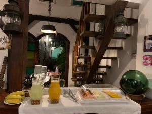 a table with a tray of food and drinks on it at Pousada Villa de Cananea in Cananéia