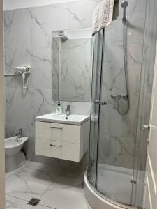 a bathroom with a shower and a sink and a toilet at GLAM Apartments Palas Mall Center Area in Iaşi