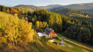 an aerial view of a house on a hill at Chalupa Barborka - Národní park Krkonoše, sauna, bazén, dětské hřiště, gril, 6 pokojů, kuchyň, společenská místnost s krbem in Vrchlabí