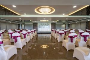 a room with rows of chairs with purple bows at Hotel Parkelite in Gannavaram
