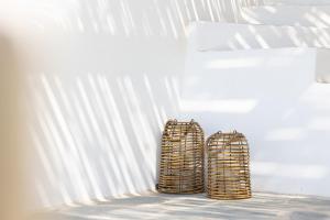 two luggage bags sitting next to a white wall at Ploes Seaside Houses in Plaka