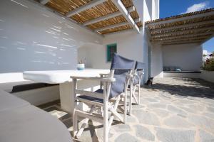 a table and two chairs on a patio at Ploes Seaside Houses in Plaka