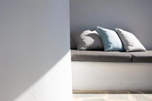 two pillows sitting on a couch in a room at Ploes Seaside Houses in Plaka
