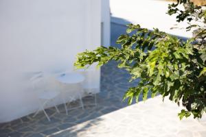 a view of two tables and chairs in a room at Ploes Seaside Houses in Plaka