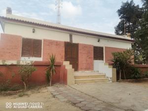 a house with brown shutters on the side of it at استراحه وفيلا ومكان ترفيهي 