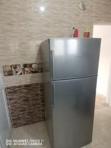 a stainless steel refrigerator in a kitchen next to a wall at استراحه وفيلا ومكان ترفيهي 