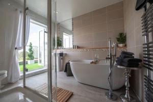 a large bathroom with a tub and a shower at Stunning Views, Hot Tub, 5 minutes to Chester 