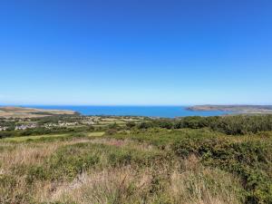 a view of the ocean from the top of a hill at Ty Canol in Mathry
