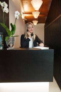 a woman sitting at a desk talking on a phone at The Place 217 in Rome