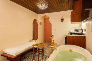 a bathroom with a tub and a table and a kitchen at The Majestic Marrakesh Studio Cairo's Downtown in Cairo