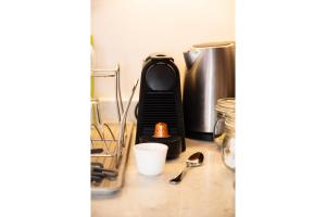 a kitchen counter with a coffee maker and utensils at The Majestic Marrakesh Studio Cairo's Downtown in Cairo