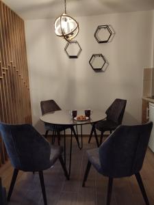 a dining room with a table and chairs and a chandelier at Twin mountain in Kopaonik