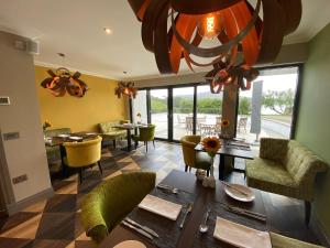 a dining room with a table and some chairs at Taransay House, Small Hotel in Portree