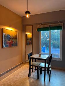 a dining room with a table and chairs and a window at VIA VARANASI-A Boutique Hotel in Varanasi