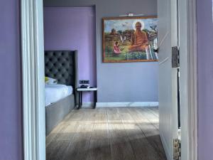 a room with a bed and a painting on the wall at VIA VARANASI-A Boutique Hotel in Varanasi