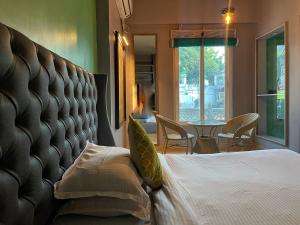 a bedroom with a bed and a table and chairs at VIA VARANASI - A Boutique Hotel at Assi Ghat in Varanasi