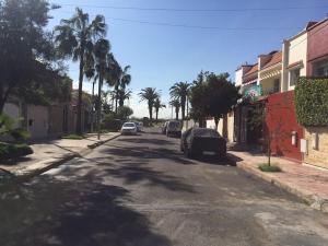 a street with cars parked on the side of the road at Petite Villa de 160m2 à Mohammedia in Mohammedia