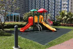a playground with a slide in a park at Jazz Residences (Destina Stays)Makati, Metro Manila in Manila