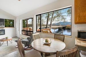 a living room with a table and chairs at River Otter in Nehalem