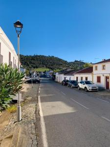a street with cars parked on the side of a road at Às Portas da Vila in Monsaraz