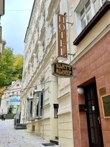 a hotel sign on the side of a building at Zlatý Sloup in Karlovy Vary