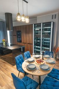 a dining room with a table and blue chairs at Apartament w Cieplicach 7 Relax in Jelenia Góra