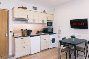 a kitchen with a table and a microwave and a washer at Black Cognac in Joigny
