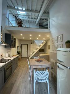 a kitchen with a table and chairs and a staircase at Corte Santa Caterina in Florence in Florence