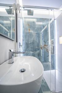 a bathroom with a white sink and a shower at Apartament w Cieplicach 7 Relax in Jelenia Góra