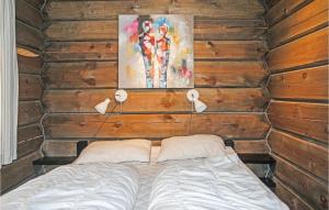 1 dormitorio con 1 cama en una pared de madera en 3 Bedroom Cozy Home In Sjusjen en Sjusjøen