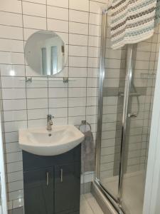 a bathroom with a sink and a shower at Cracatinni Mews in Roundwood