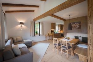 a living room with a couch and a table at Hallerwirt Homes in Aurach bei Kitzbuhel