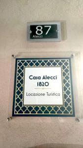 a sign on a wall with a sign for a restroom at Casa Alecci 1820 in Modica