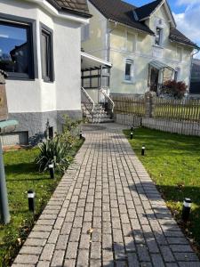 a brick walkway in front of a house at Anil‘s Ferienhaus in Olsberg