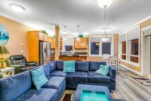 a living room with a blue couch and a kitchen at Oceanfront Contemporary in Lincoln City